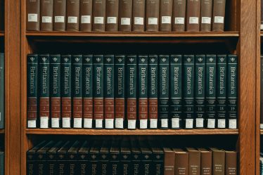 books on brown wooden shelf